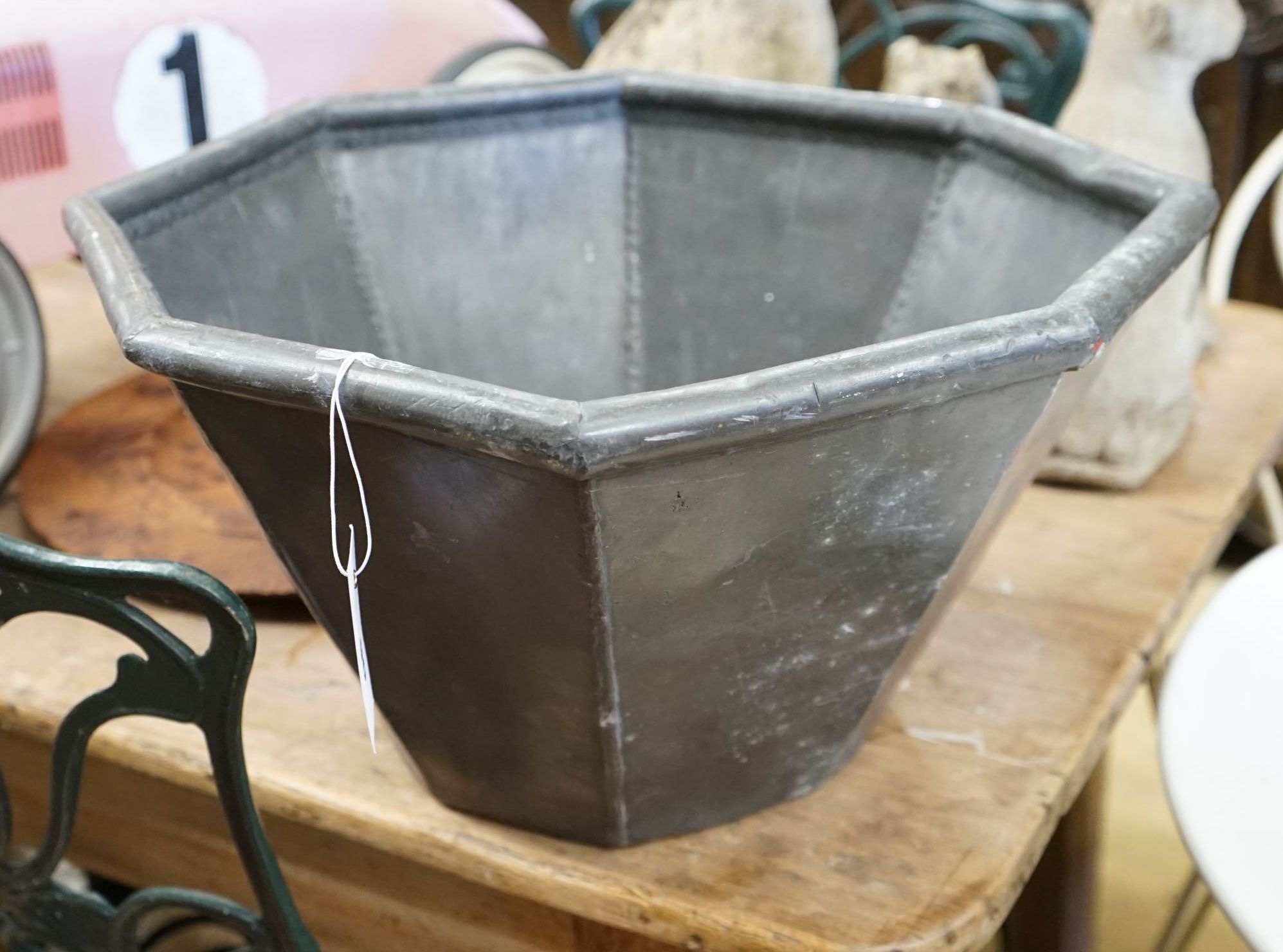 An octagonal lead garden planter, width 44cm, height 25cm